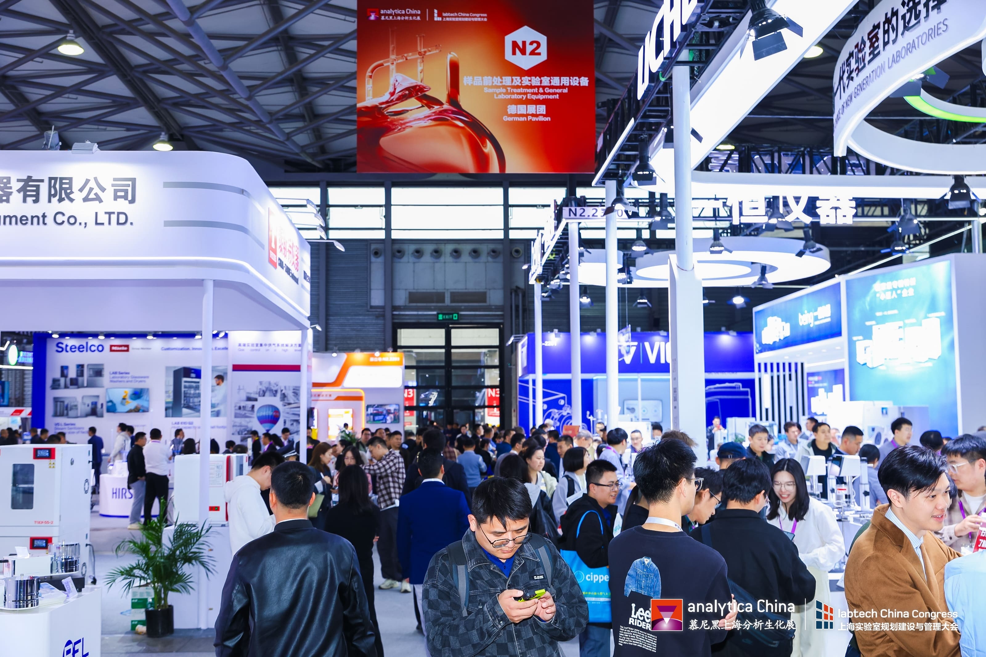 Exhibitors and visitors networking at the bustling analytica China 2024 exhibition