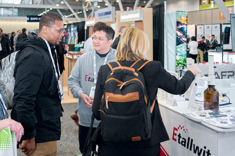 Etallwit team engaging with visitors at PITTCON 2025