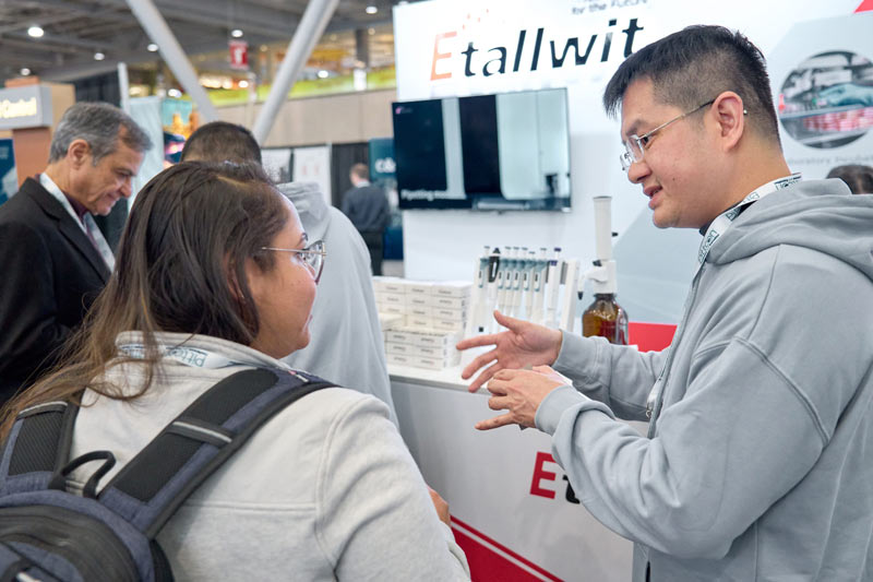 Etallwit team engaging with visitor at PITTCON 2025