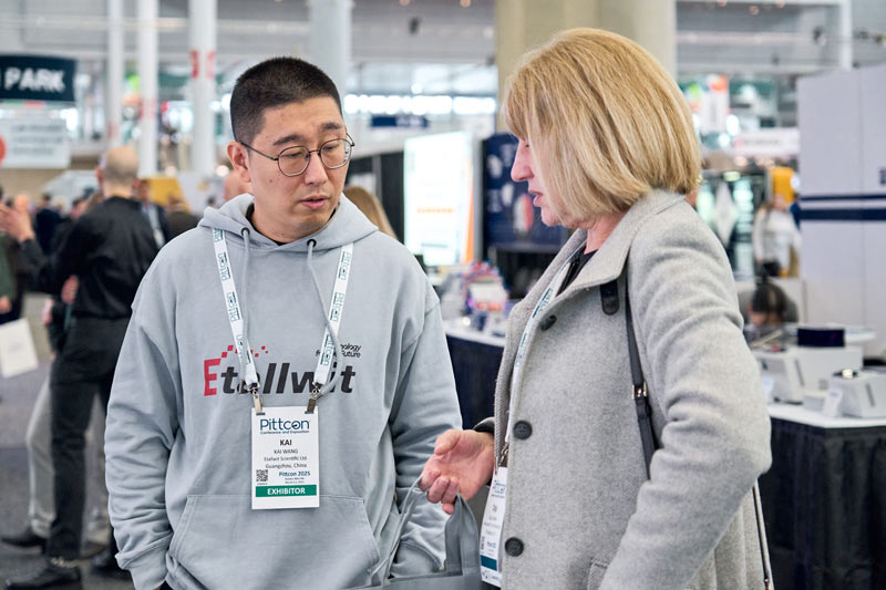 Business discussions at Etallwit booth during pittcon 2025